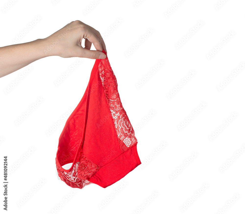 Foto de The girl holds red female panties in her hand on a white  background. Bad smell from underwear, hygiene. Isolate, copy space for text  do Stock