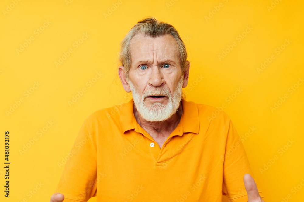 Portrait of happy senior man yellow shirt posing emotions yellow background Portrait of happy senior man yellow shirt posing emotions yellow background