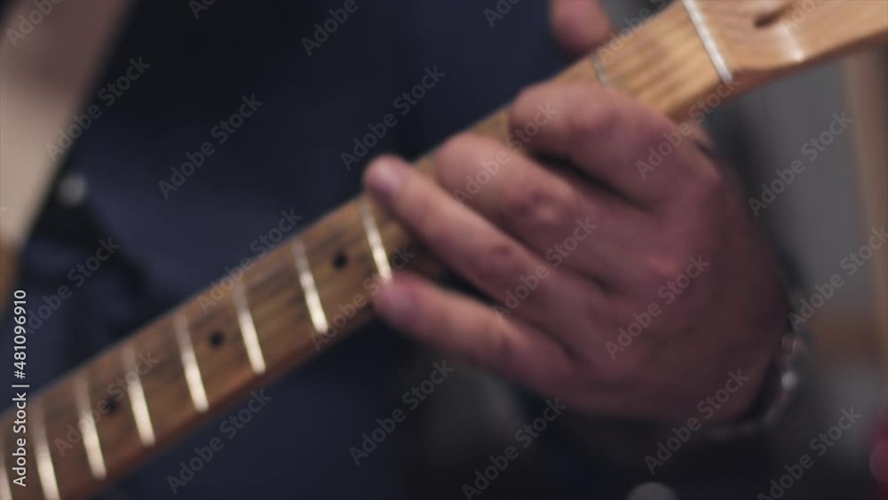 Close up of the fingers of a guitar player playing a solo on a guitar. Close up of the fingers of a guitar player playing a solo on a guitar.
