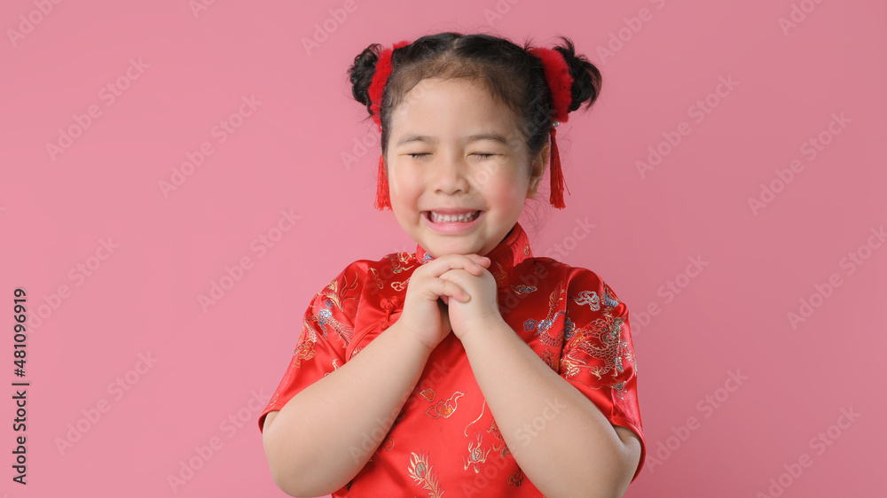 Smiling cute asian little girls in red chinese traditional dress.Happy Chinese new year concept.
