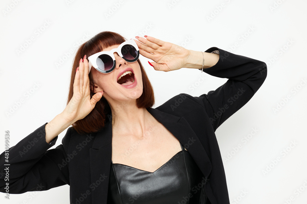 attractive woman in a black jacket red nail polish stylish sunglasses Lifestyle unaltered attractive woman in a black jacket red nail polish stylish sunglasses Lifestyle unaltered