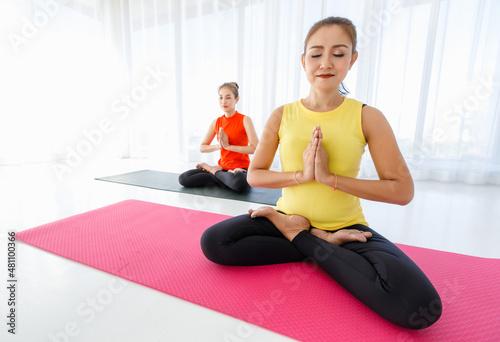 Asian women meditating with closed eyes