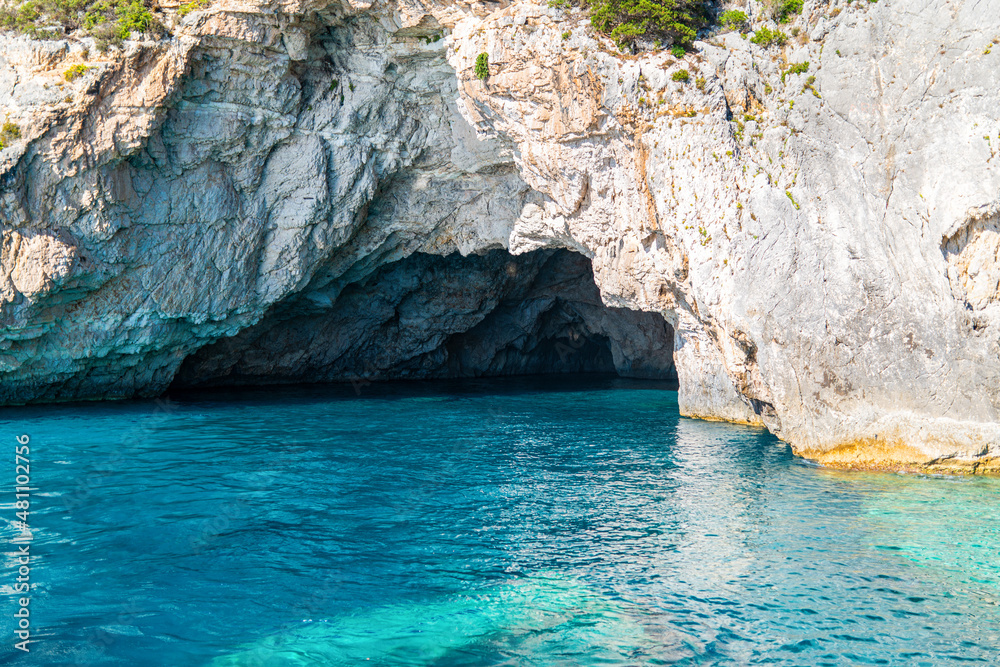 White-stoned rocks creating cave in Corfu island sea beach