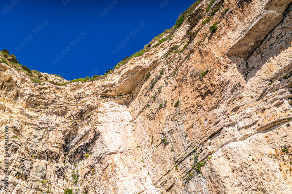 High cliffs with forest and rocks on shore of Corfu island High cliffs with forest and rocks on shore of Corfu island