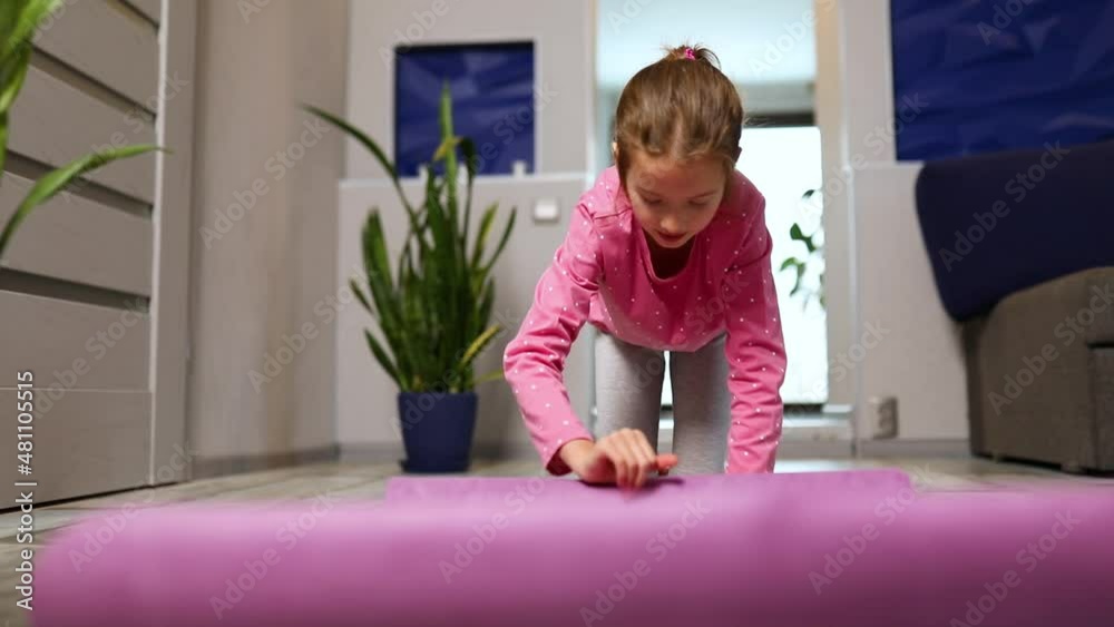 Child, little girl rolling up yoga pilates mat on floor after stretching exercises, practicing yoga, Playing sports, Healthy lifestyle. Stock ビデオ | Adobe Stock 