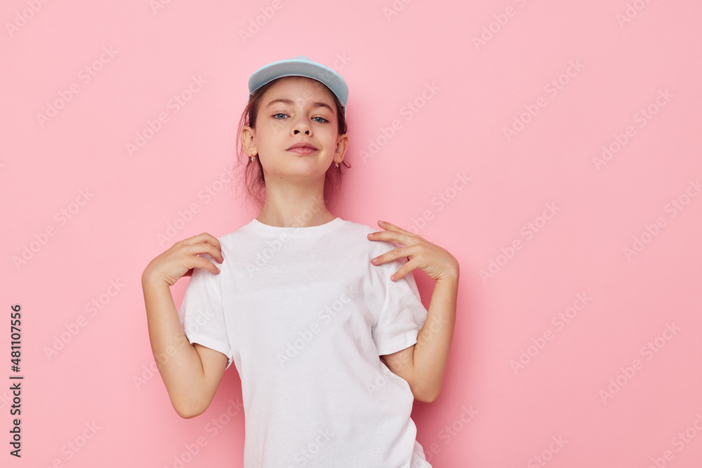 Portrait of happy smiling child girl posing white tshirt emotion pink background Portrait of happy smiling child girl posing white tshirt emotion pink background
