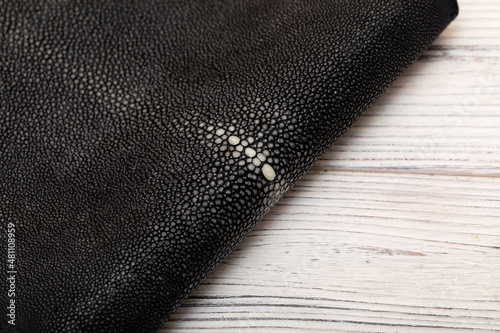 natural colored black rays leather on the wooden table