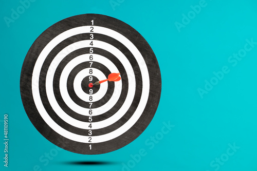flying dart board isolated on blue background