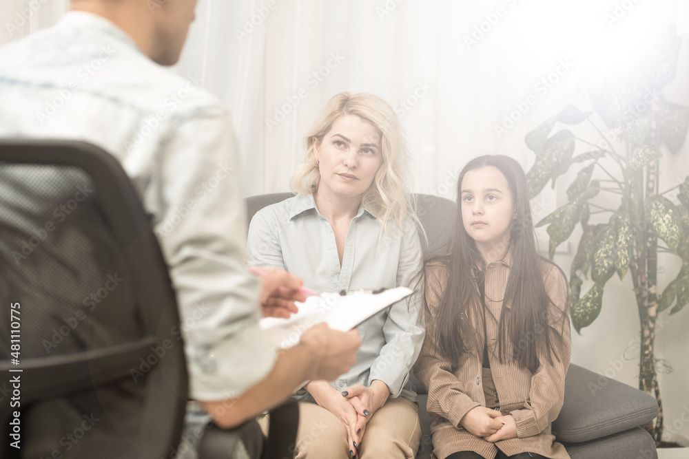 Child psychotherapist working with little girl and her mother in office Child psychotherapist working with little girl and her mother in office