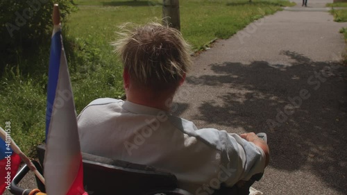 A woman with a congenital malformation of the limbs drives an electric wheelchair with her finger.