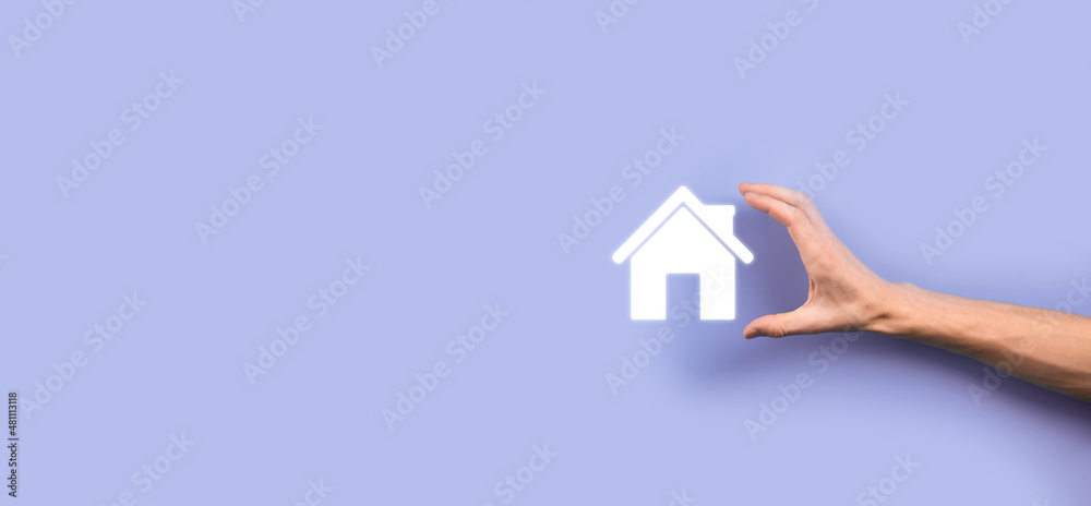 Naklejka premium Real estate concept, businessman holding a house icon.House on Hand.Property insurance and security concept. Protecting gesture of man and symbol of house
