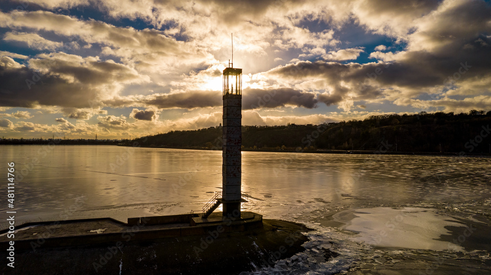 Aerial view of a lighthouse on a frozen lake