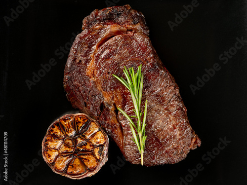 Barbecue meat steak grill served on black background plate, macro overlay, flat lay, top view