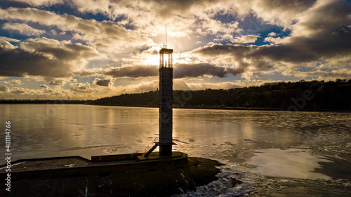 Aerial view of a lighthouse on a frozen lake