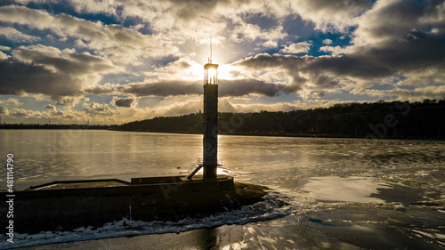 Aerial view of a lighthouse on a frozen lake