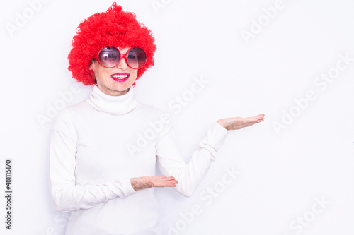 woman in wig and glasses pointing or showing with finger isolated with copy space