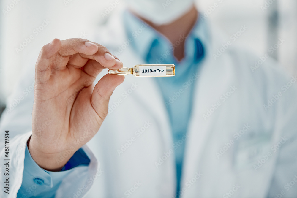It's finally here. Cropped shot of a scientist holding an ampoule with 2019-nCov on it. It's finally here. Cropped shot of a scientist holding an ampoule with 2019-nCov on it.