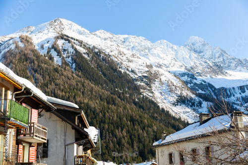Scenic view of small village and ski resort of Argentiere surrounded by snow-capped French Alps in Chamonix Valley on sunny winter day, France