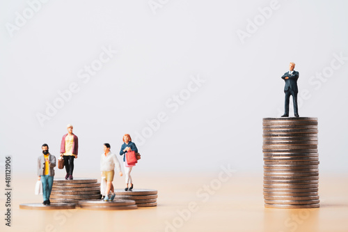 Murais de parede Businessman standing on higher coins stacking with shoppers people for investor concept