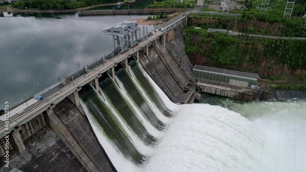 Aerial side view of water discharge at hydroelectric power plant Aerial side view of water discharge at hydroelectric power plant