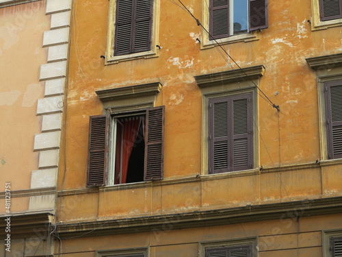 Rome Traditional Orange Brown Building Facade with Open Window and Red Curtain, Italy
