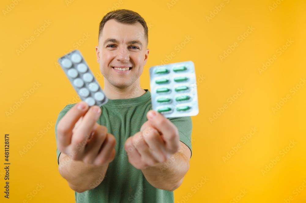 Vitamin complex. Handsome man take medication. Health care. More commonly prescribed antidepressants. Investment in health. Medicines concept. Food additives vitamins for male health