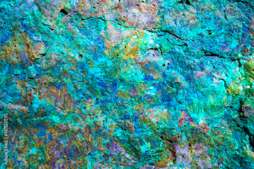 Background from dracocene crystals of stones. Fluorite stone in the rocks of the adit. Mineral stones in their natural environment. Semiprecious stones texture.