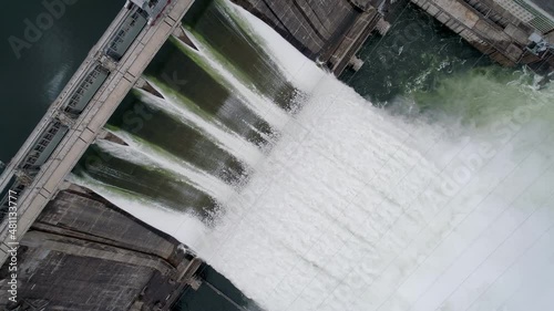 Aerial top down view of water discharge at hydroelectric power plant