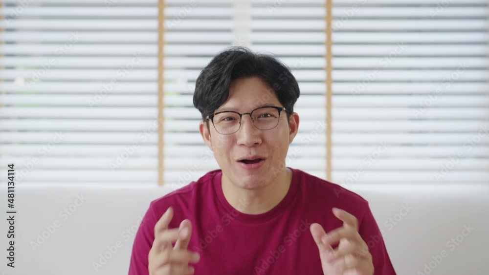 Headshot asia people mature young adult male vlogger with good luck red shirt happy laugh smile look at camera in dating call film smartphone app. Influencer live stream on vlog webcam at home sofa. Headshot asia people mature young adult male vlogger with good luck red shirt happy laugh smile look at camera in dating call film smartphone app. Influencer live stream on vlog webcam at home sofa.