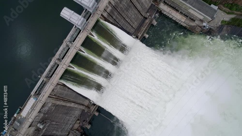 Aerial top down view of water discharge at hydroelectric power plant photo