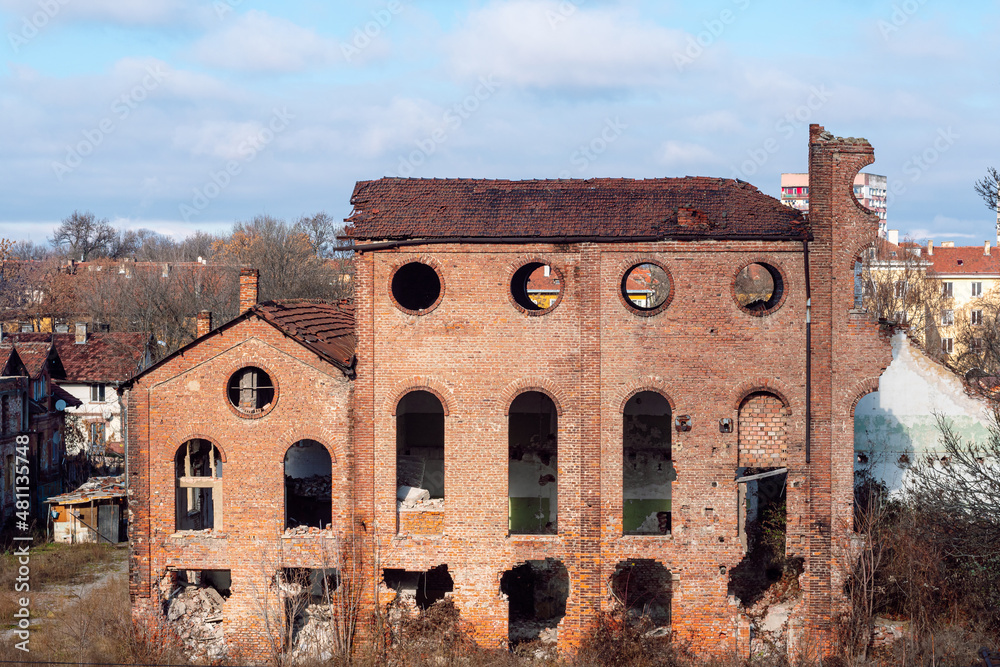 Abandoned factory. Brick facade of the old crumbling sugar factory in Sofia, Bulgaria. Industrial building from period of Modernism in Bulgaria. 