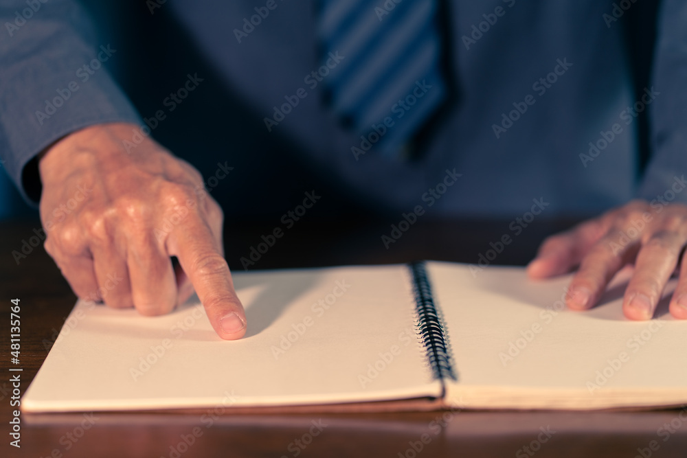 Man hand pointing a book. Selective focused Man hand pointing a book. Selective focused