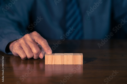 Man hand with wood block. Business concept.