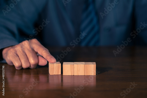 Man hand with wood block. Business concept.