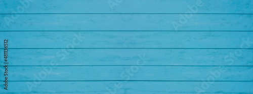 Old weathered wooden plank painted in turquoise blue color. Vintage beach wood background.