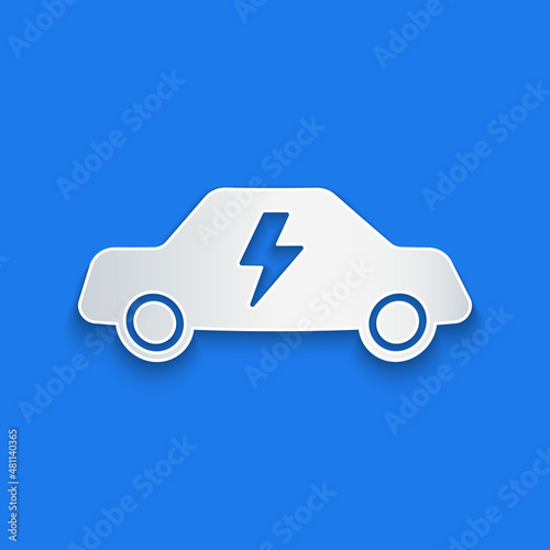 Paper cut Electric car and electrical cable plug charging icon isolated on blue background. Renewable eco technologies. Paper art style. Vector