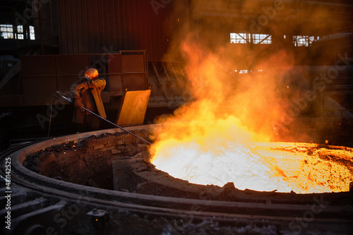 Metallurgist at the ladle with liquid metal. Steel ladle degassing unit VD  VOD. Ladle with hot liquid metal.