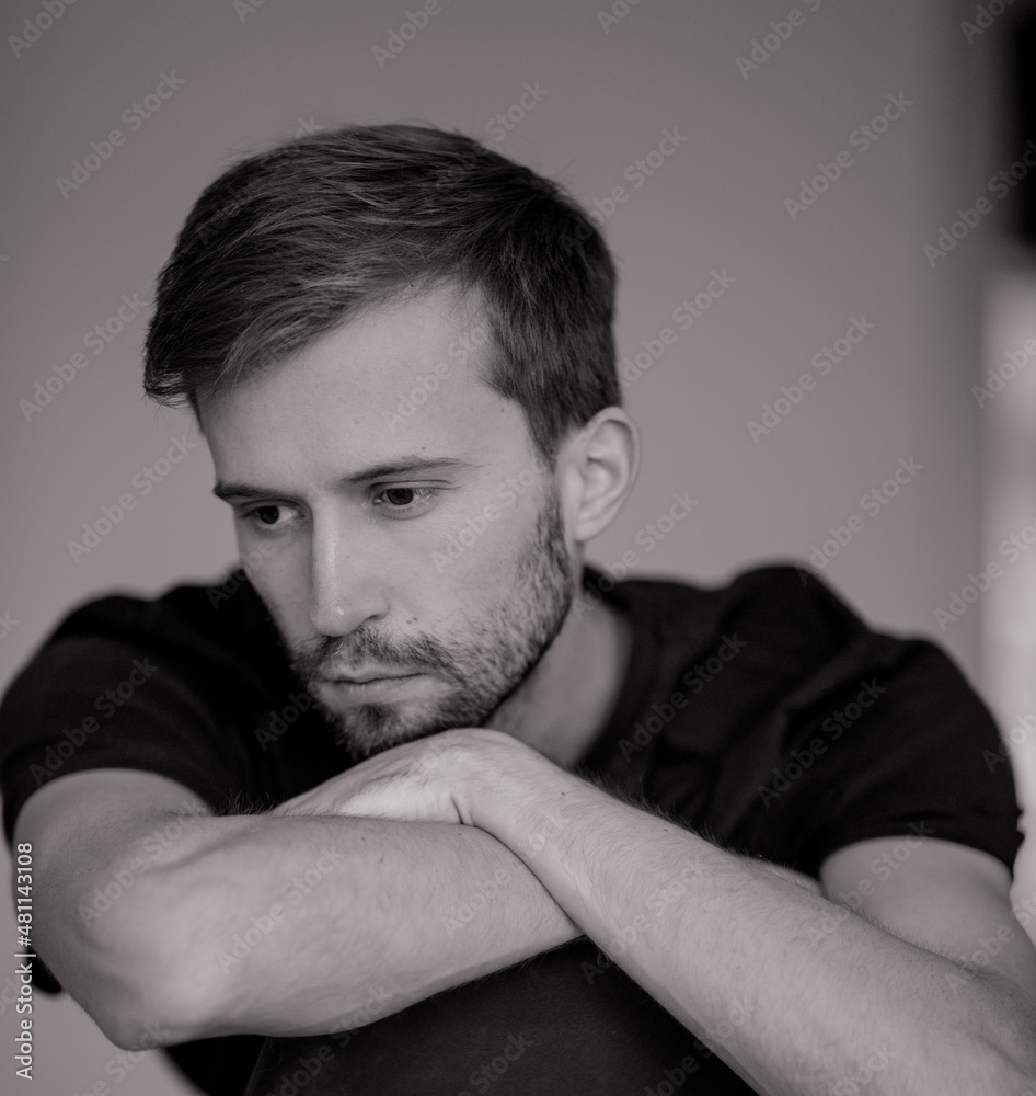 Fototapeta premium Black and white portrait of young pensive man.