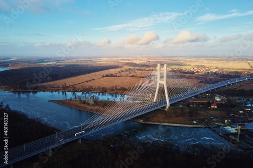 Large modern bridge over river in europe city with car traffic, aerial view. Redzinski bridge over Oder in Wroclaw, Poland photo