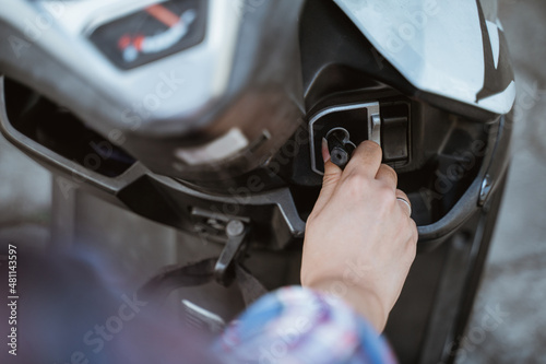 woman's hand holding the ignition while ride a motorcycle