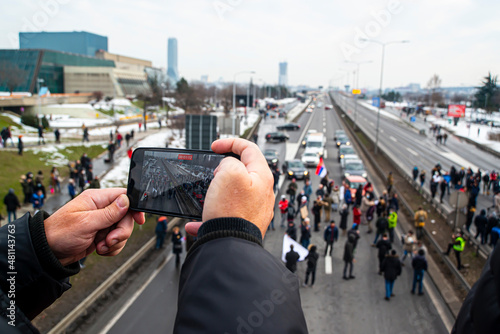 filming  with mobile phone protesters blocking the highway