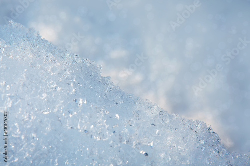 Fresh snow texture background in blue tone and sunlight.