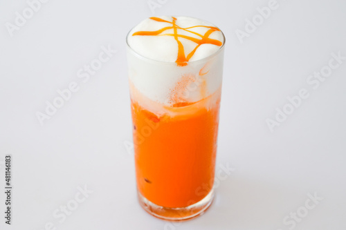 Glass Thai Iced tea with milk on white background.