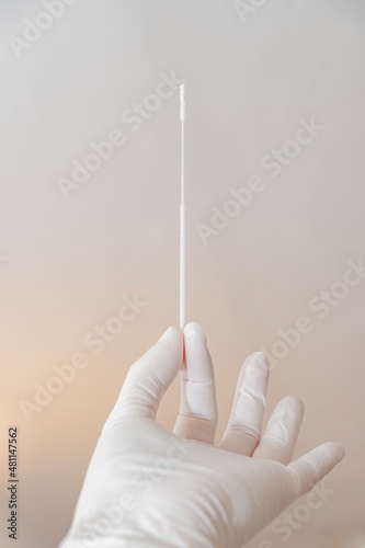 Hand holding quick flu test swab