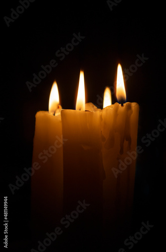 Burning wax candles on a dark background. copyspace.
