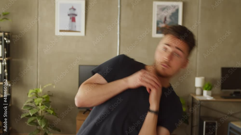 Young man warming up before exercising at home in living room Young man warming up before exercising at home in living room