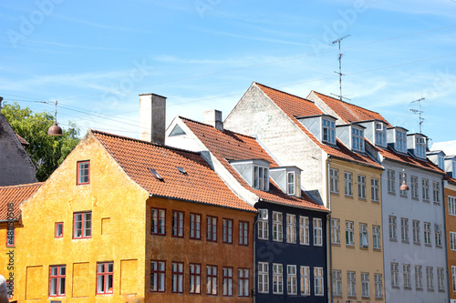 Copenhagen, Denmark-Christianshavn canal, colorful facades of old houses. King Christian's Harbour is a neighbourhood in Copenhagen. Real estate investment. Rent an apartment. Expensive housing.  © Natalia