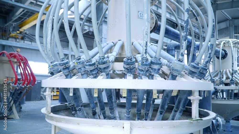 White liquid coming out from the pipes attached to the tank. Automated