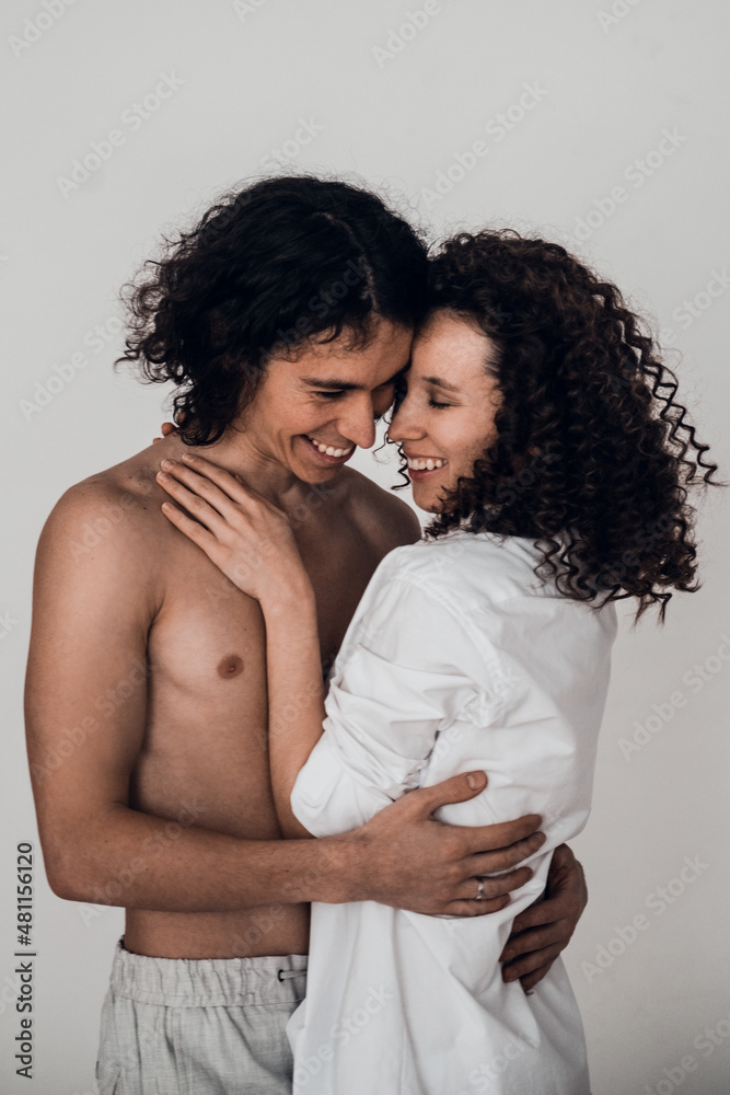 happy heterosexual couple man and woman embracing white background