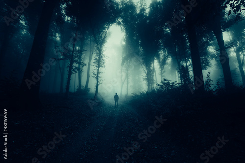 man walking alone on dark f...